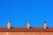 Chimneys on house roof against blue sky