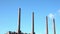 Chimneys of a large power station in front of a bright blue sky