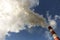 Chimneys with steam production of a thermal power station. Cloudy sky is polluted by smoke from the chimney