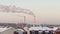 Chimneys of thermal power plants smoke against the backdrop of a winter cityscape. Bialystok, Poland