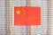 China flag on a background from dollar banknotes. Concept of the relationship of the money of china in relation to the