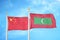 China and Maldives two flags on flagpoles and blue cloudy sky