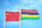 China and Mauritius two flags on flagpoles and blue cloudy sky