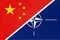 China national fabric flag from textile vs North Atlantic Treaty Organization sign and symbol of international Alliance