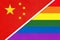 China national fabric flag vs rainbow flag of LGBT community from textile opposite each other