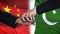 China and Pakistan officials exchanging tank for money, flag background, army