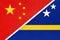 China or PRC vs Curacao national flag from textile. Relationship between asian and american countries