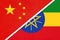 China or PRC vs Ethiopia national flag from textile. Relationship between Asian and African countries