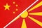 China or PRC vs North Macedonia national flag from textile. Relationship between asian and european countries