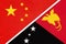 China or PRC vs Papua New Guinea national flag from textile. Relationship between Asian and Oceania countries