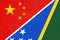 China or PRC vs Solomon Islands national flag from textile. Relationship between Asian and Oceania countries