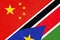 China or PRC vs South Sudan national flag from textile. Relationship between Asian and African countries