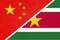 China or PRC vs Suriname national flag from textile. Relationship between asian and american countries