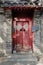 China Red Door with Mandarin writing in old hutong in Beijing, China. Writing on door mean good wishes as Lunar New Year