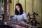 CHINA, SHANGHAI - NOVEMBER 7, 2017: Chinese girl is playing Guzheng or zheng. Chinese plucked zither a traditional