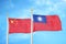 China and Taiwan two flags on flagpoles and blue cloudy sky