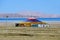 China, Tibet. Construction with colorful flags with mantras, indicating a place of power and worship, on the shore of lake Selling