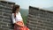 China travel at Great Wall - Woman sitting on the famous tourist attraction