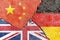 China VS Germany VS Russia flags on cracked wall background, international political conflict