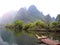 China, Yangshuo, reed rafts on the river between the hills