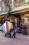 CHINATOWN, BANGKOK, THAILAND - Feb 2, 2019: Asain worker pushing shopping cart and shops on Yaowarat road, the main street of