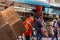 CHINATOWN, BANGKOK, THAILAND - Feb 2, 2019: Asain worker pushing shopping cart and shops on Yaowarat road, the main street of