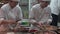 Chines chefs preparing Dim sum dumplings food at Yuyuan Tourist Mart in Shanghai, China