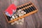 Chinese abacus, small house and scattered euro coins