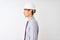 Chinese architect man wearing tie and helmet standing over isolated white background looking to side, relax profile pose with