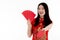 A Chinese beautiful woman with long black hairs in red traditional dress is smiling with happy face and holding original native