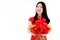 Chinese beautiful woman with long black hairs in red traditional dress is smiling and showing a red basket gift filled with