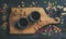 Chinese black tea in black stoneware cups on wooden board