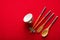 Chinese bowl, fork, spoon and chopsticks on red mat