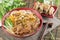 Chinese bowl of noodle with fried pork ribs and herbs on the tab