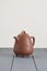 Chinese brown clay teapot on wooden table copyspace