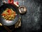 Chinese cellophane noodles in a frying pan wok with ginger, spices and vegetables