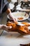 Chinese chef cooking peking roasted duck at the kitchen of restaurant