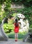 Chinese cheongsam model in Chinese classical garden Standing in the middle of beautiful gate at Qiyuan Garden