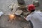 Chinese Construction Worker Cutting Metal Rebar