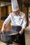 Chinese cook arranges food on plates