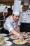 Chinese cook arranges food on plates