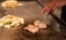 Chinese cook prepares spicy dish fried beef and vegetables. Hands chefs prepare Chinese food close-up.