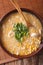 Chinese corn and chicken soup in a bowl close-up. vertical top v