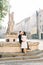 Chinese cute bride and groom young newlyweds just married couple posing on the stone stairs on streets of old city on