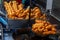 Chinese deep fried dough in hot oil on steel pan. Youtiao, Padnoongo or fried flour sticks