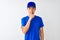 Chinese deliveryman wearing blue t-shirt and cap standing over isolated white background asking to be quiet with finger on lips