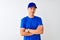 Chinese deliveryman wearing blue t-shirt and cap standing over isolated white background happy face smiling with crossed arms