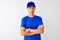 Chinese deliveryman wearing blue t-shirt and cap standing over isolated white background skeptic and nervous, disapproving