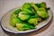 Chinese dish cabbage pak choy fried in a wok with sauce, served on a white plate. Beijing, China.