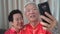 Chinese elder coupl selfie in New Year theme technology to stay connect with family